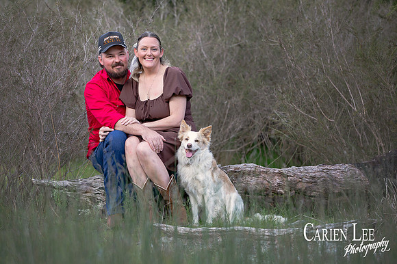 Couple embracing with their dog beside them during Bunbury photoshoot