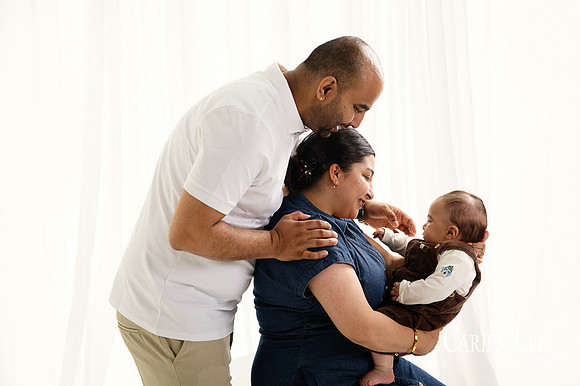 Baby making eye contact with grandparents during Bunbury family photo session