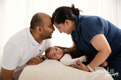 Parents laughing with baby during relaxed family portrait session in Bunbur