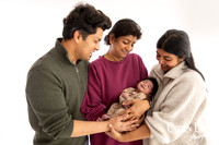 Family of three during a newborn photography session in Bunbury, parents holding their baby