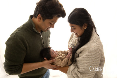 Parents gazing at their newborn during family and newborn photography session in Bunbury