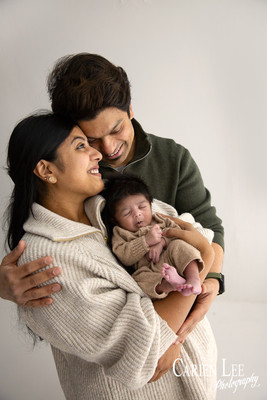 Family of three during a newborn photography session in Bunbury, parents holding their baby