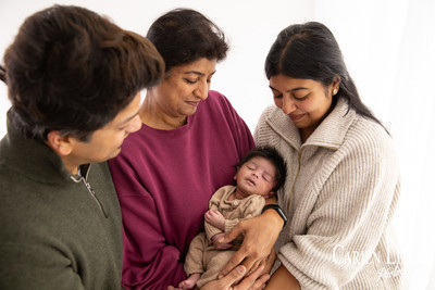 Family of three during a newborn photography session in Bunbury, parents holding their baby
