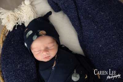 Sleepy newborn baby Noah curled up during Bunbury newborn photography session