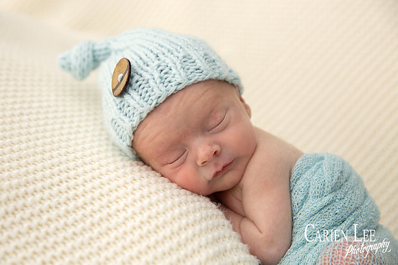 Newborn baby Noah in classic curled sleeping pose, Bunbury photography studio