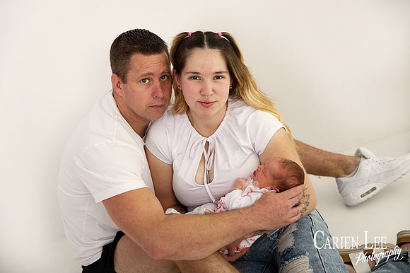 newborn baby girl and parent during a newborn shoot
