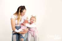 Mother and 2 daughters during a newborn session