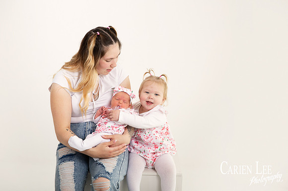 Mother and 2 daughters during a newborn session