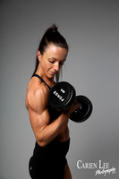 Close-up fitness portrait of a woman performing a dumbbell curl in a Bunbury photography studio.