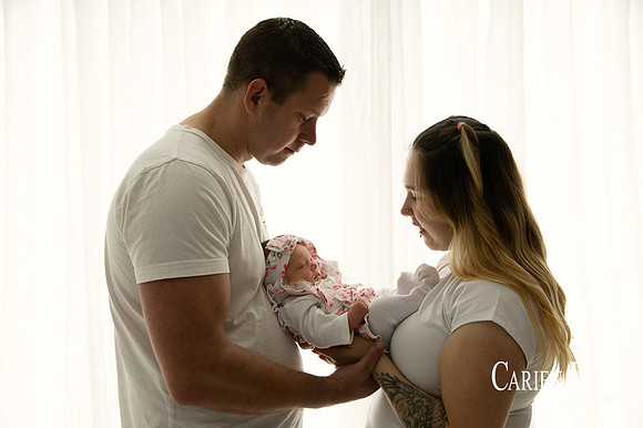 Parents with their newborn girl during newborn photo session in Bunbury