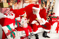 Child posing with Santa during a professional Christmas photography session in Bunbury WA