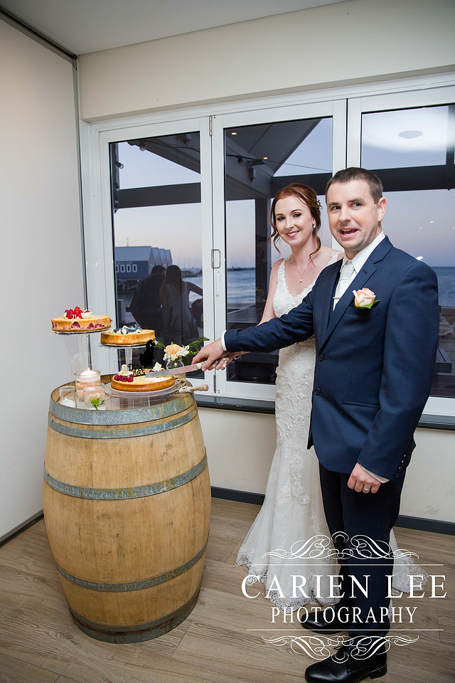 Bride and groom cutting the cake at busselton wedding