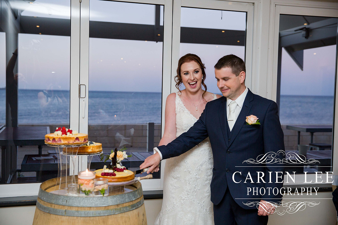Bride and groom cutting the cake at busselton wedding