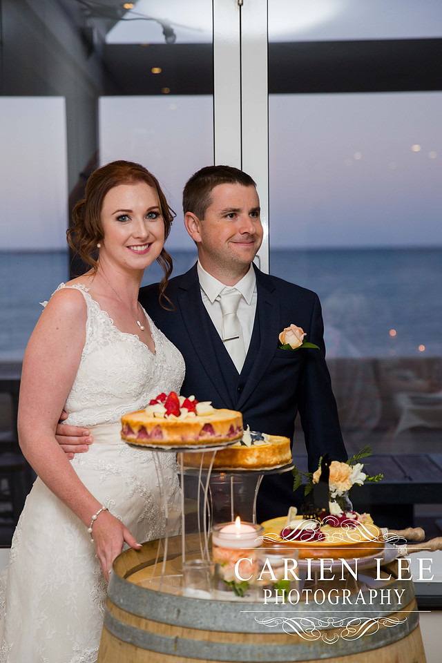 Bride and groom cutting the cake at busselton wedding