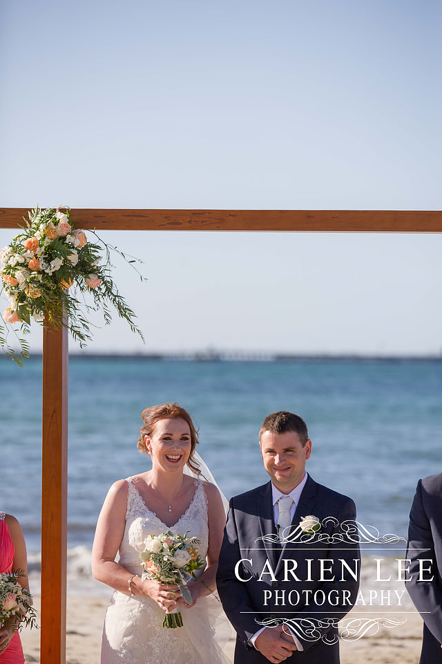 Newly wed couple on the beach in busselton in front of the Busselton Jetty