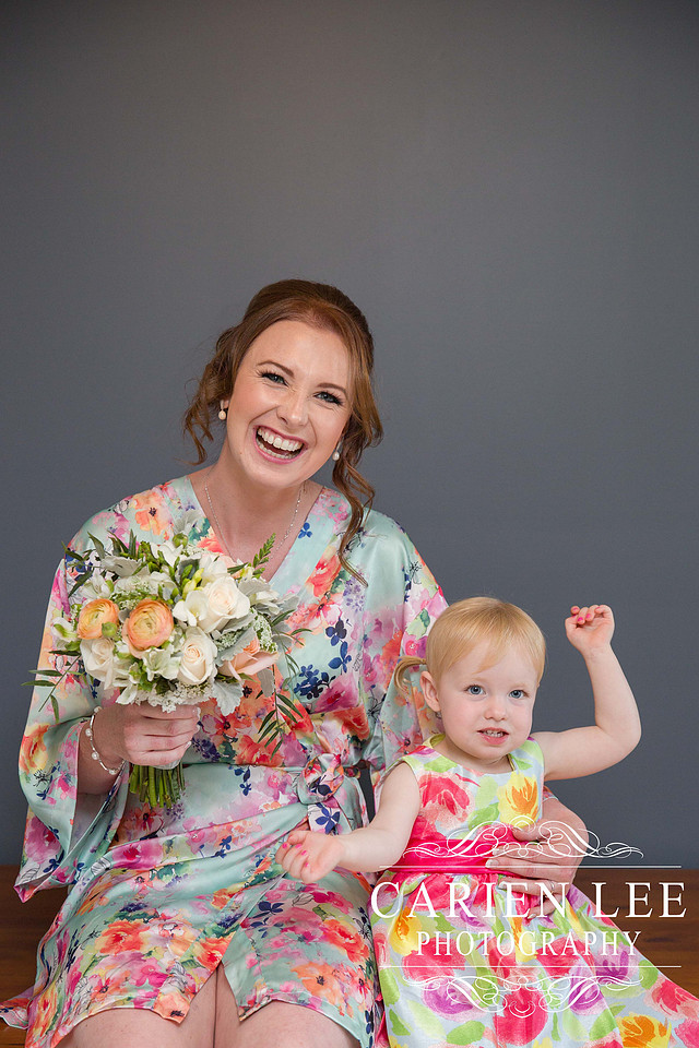 Bride and flower girl excited before getting dressed