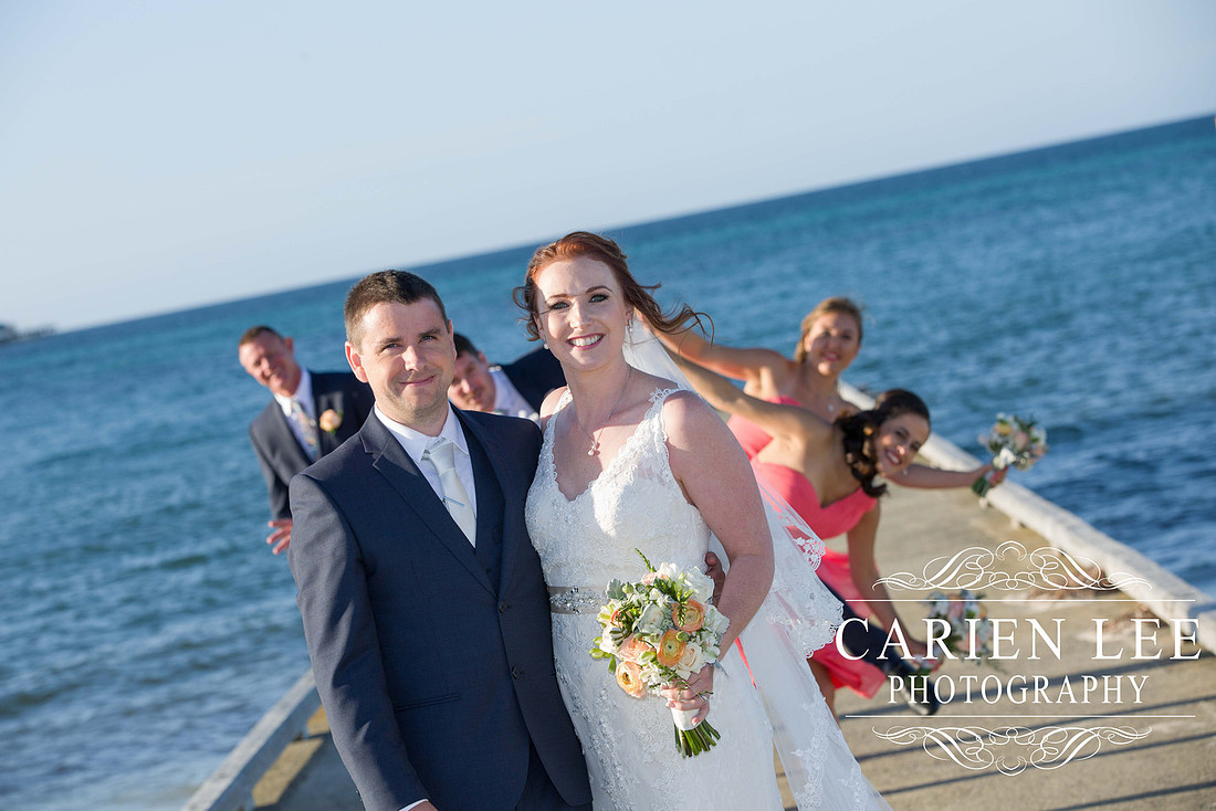 Bride and groom with bridal party on Busselton Beach at busselton jetty