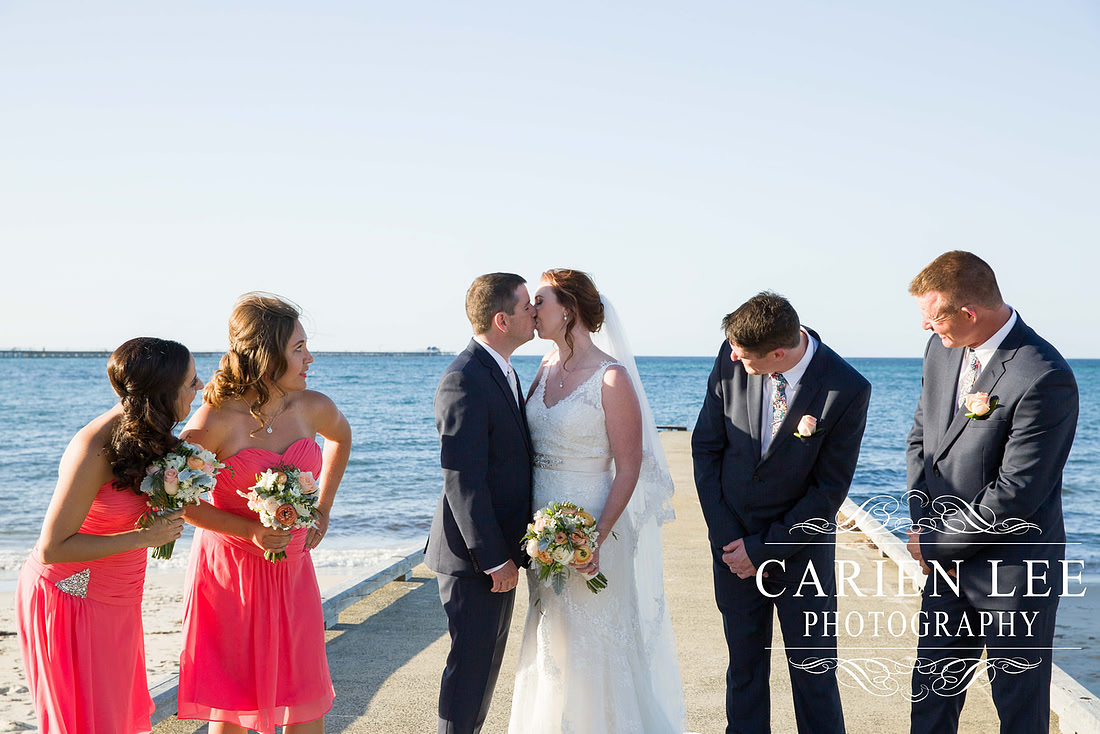 Bride and groom with bridal party on Busselton Beach at busselton jetty