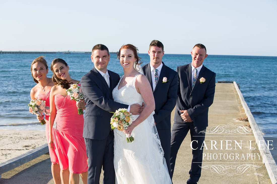 Bride and groom with bridal party on Busselton Beach at busselton jetty