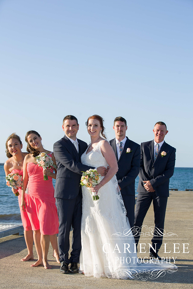 Bride and groom with bridal party on Busselton Beach at busselton jetty