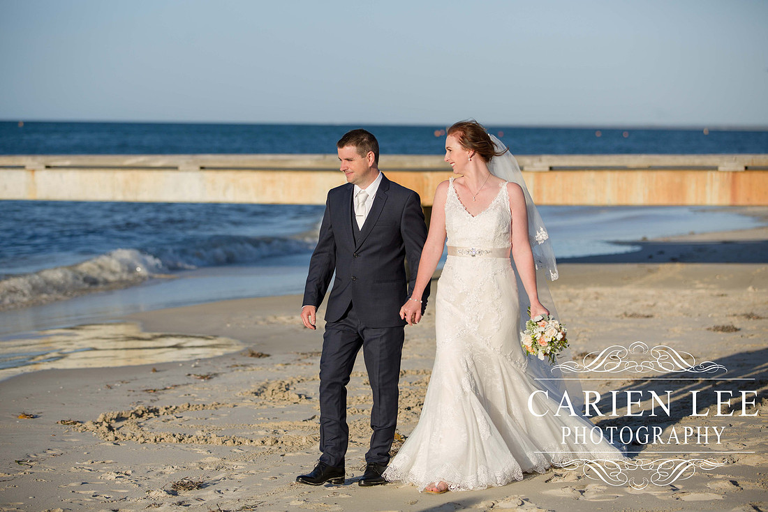Bride and groom on Busselton Beach at busselton jetty