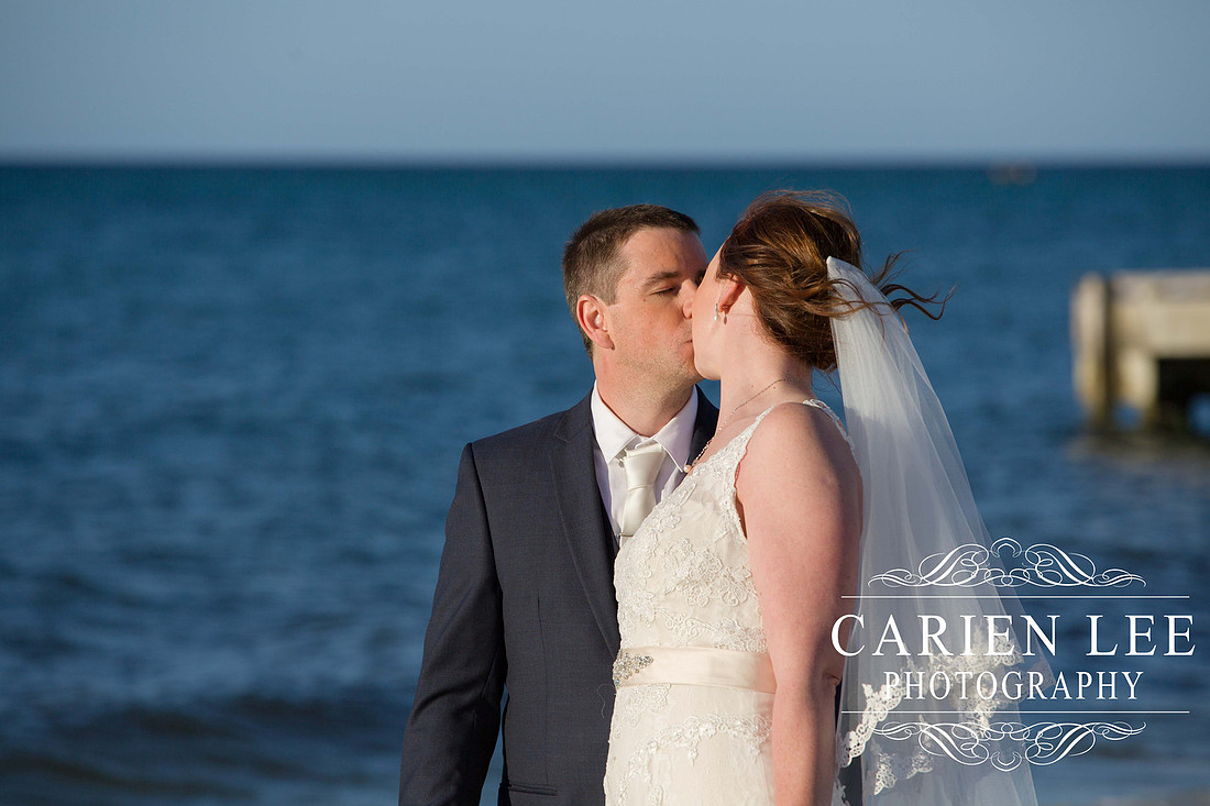 Bride and groom on Busselton Beach at busselton jetty