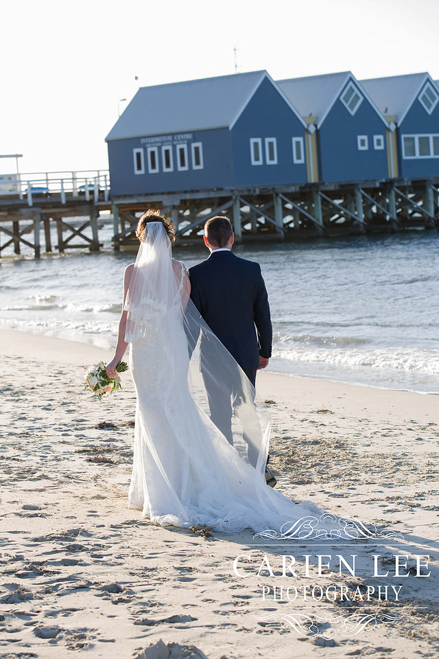 Bride and groom on Busselton Beach at busselton jetty