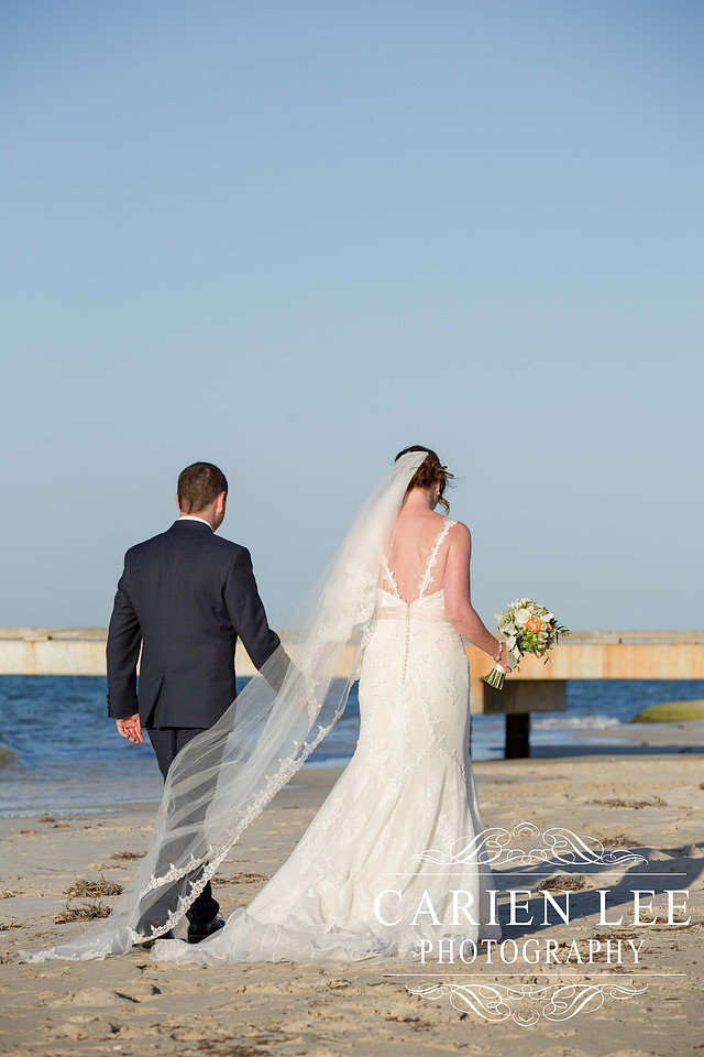 Bride and groom on Busselton Beach at busselton jetty
