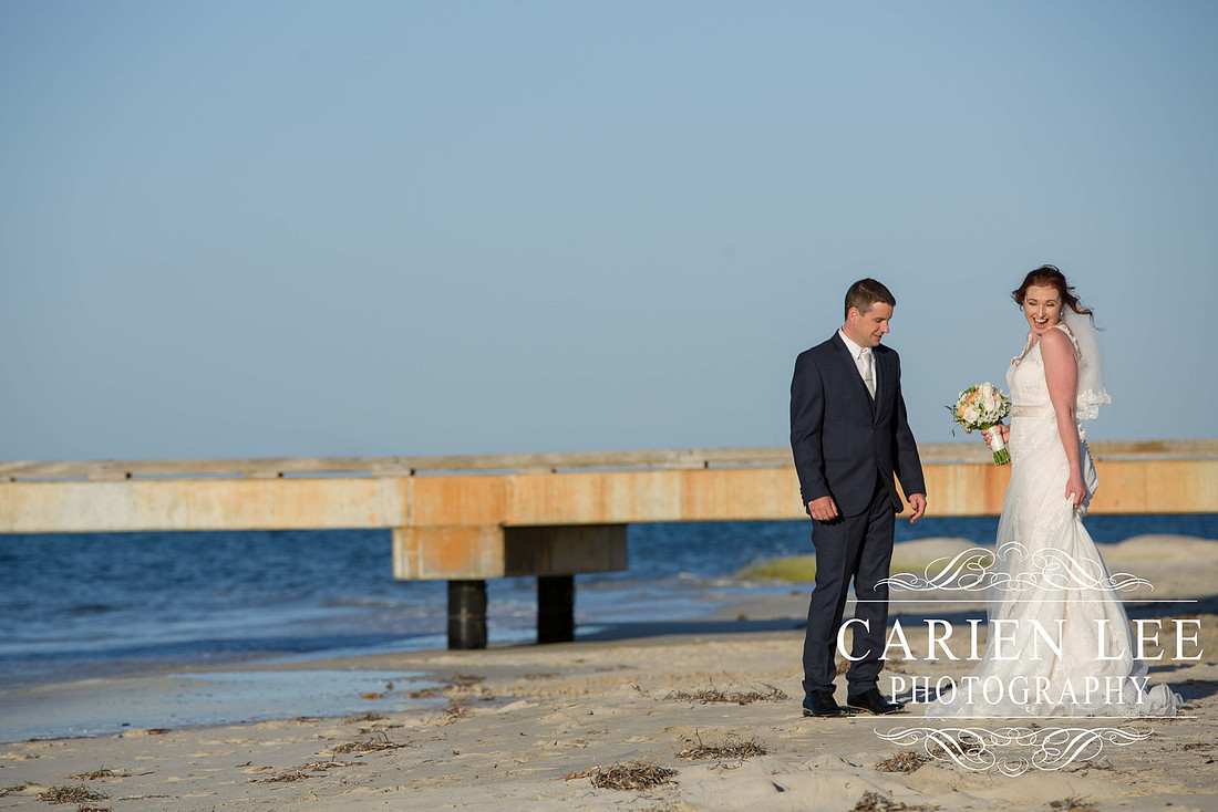 Bride and groom on Busselton Beach at busselton jetty