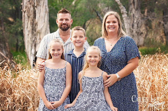 Family of four enjoying outdoor photography session in Bunbury