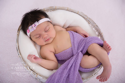 Newborn baby wrapped in soft blankets during Bunbury newborn photography session