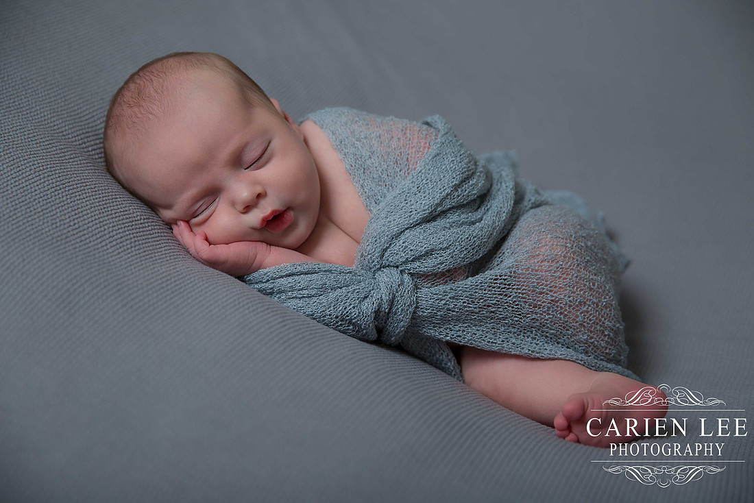 newborn boy wrapped in blue in Bunbury Studio