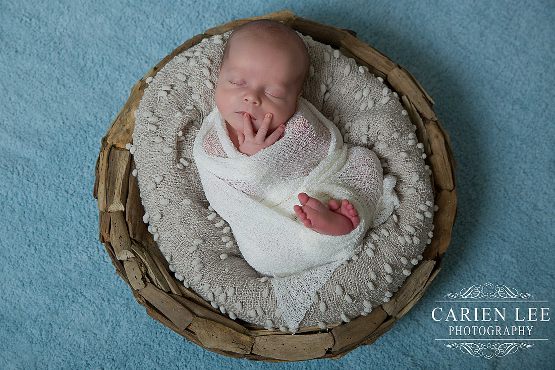 Newborn boy in a basket in Bunbury studio