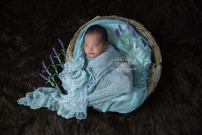 Newborn baby wrapped in soft blankets during Bunbury newborn photography session
